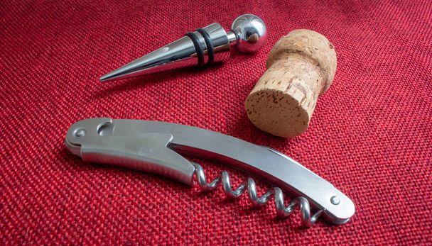 Wine set with a corkscrew, a metallic stopper and a cork - Photo, Image