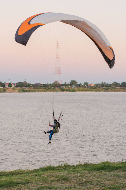 young woman parachuting down to the ground Riverside - Photo, Image