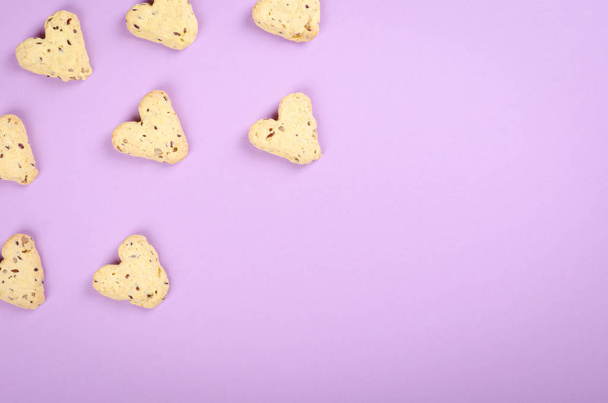 Flax seed cookies on purple background composition, heart shape. Flat lay and top view photo with copy space. - Photo, Image