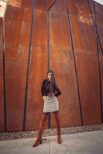 Beautiful girl model posing against the background of the modern building - 写真・画像