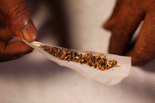 black man hands rolled marijuana joint close up - Photo, Image