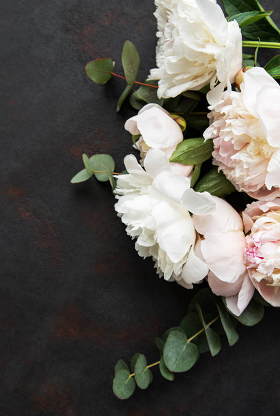 Background with pink peonies on a black  concrete background - Photo, Image