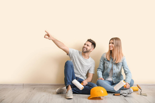 Young couple with tools resting during repair in new apartment - Photo, Image
