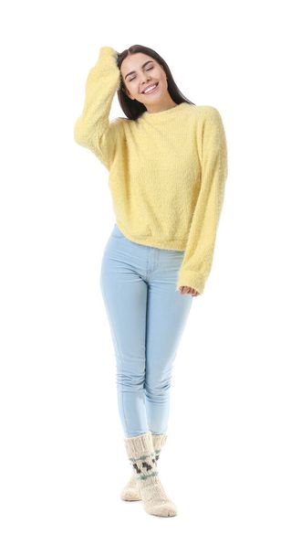 Beautiful young woman in warm sweater on white background - Foto, afbeelding
