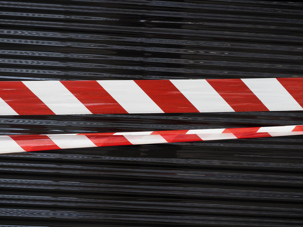 fita de barreira vermelha e branca sobre fundo de nylon preto
 - Foto, Imagem