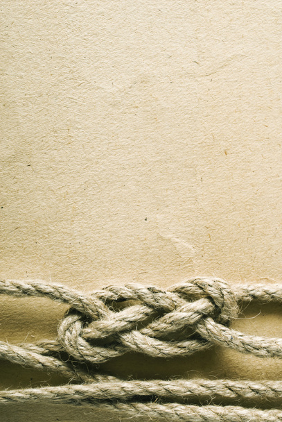 Aged rope on the old paper background - Fotografie, Obrázek