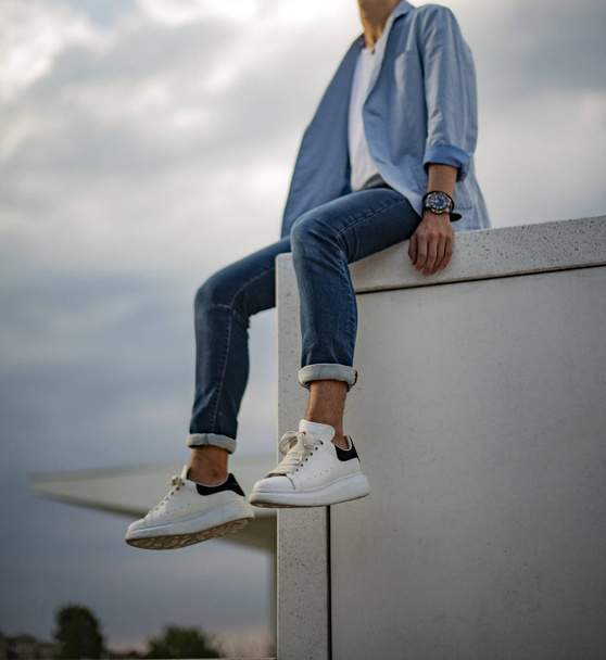 Milan, Italy - July 14, 2019: Man wearing a pair of Alexander McQueen sneakers in the street - Zdjęcie, obraz