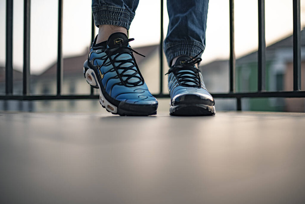 Milan, Italy - December 1, 2018: Young man wearing Nike Air Max Plus TN Hyperblue shoes in the street - illustrative editorial - Foto, Imagen