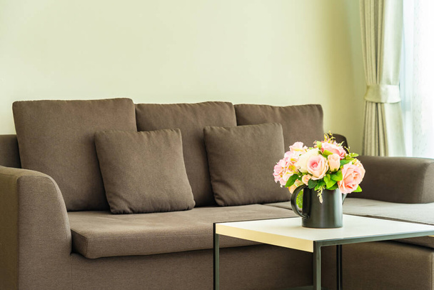 Vase flower on table with pillow and sofa decoration interior of living room area - Φωτογραφία, εικόνα