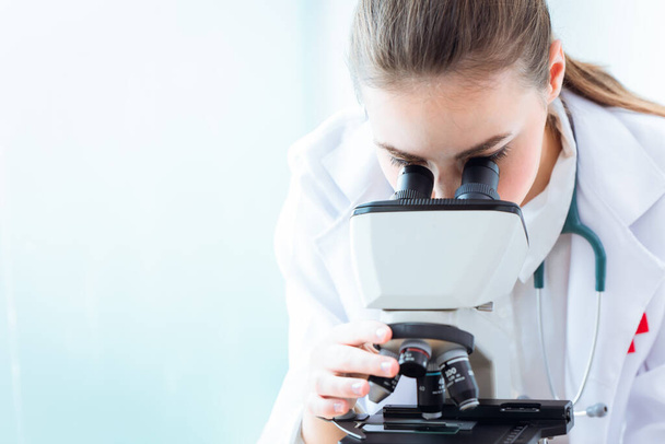 medical doctor scientist working women looking at microscope in science laboratory research new medicine - Foto, Imagem