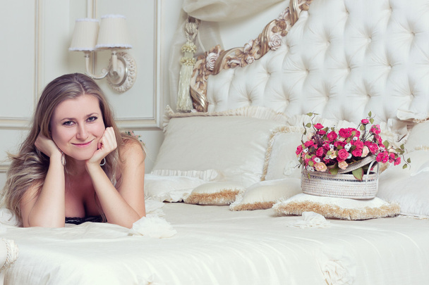 girl lying in bed with roses - Photo, Image