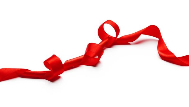 Red ribbon isolated on white. creative photo. - Φωτογραφία, εικόνα