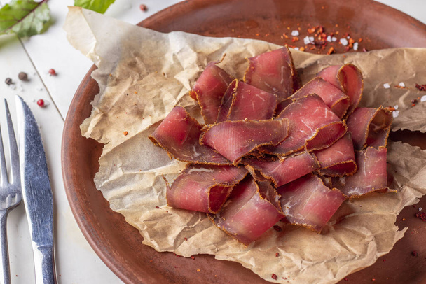 Basturma - jerky, meat appetizer for beer on a plate close-up - Photo, Image