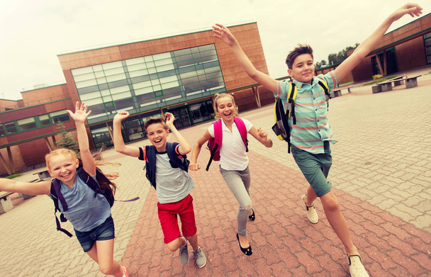group of happy elementary school students running - Фото, изображение