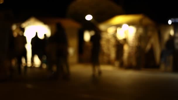 Out of focus of people in a street at night. Blurred. Not clear. Shallow DOF. - Footage, Video