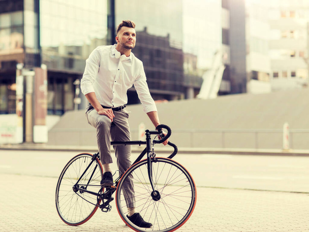 man with bicycle and headphones on city street - Zdjęcie, obraz