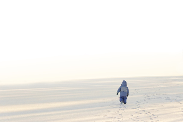 little lonely boy in winter on ice in the snow 2020 - Φωτογραφία, εικόνα