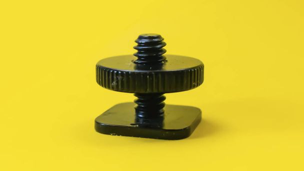 Screw hot shoe on a yellow background - Photo, Image