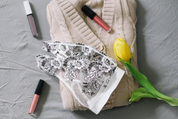 Female fashion background with lingerie, lipstick and flowers. Flat lay, top view. Beauty concept for blog, social media, magazine - Foto, Imagem
