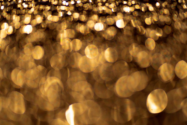 Sparkling light boke blur. Gold glitter particles background. - Foto, Imagem