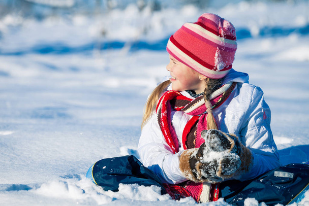 Cute little girl playing  on winter snow day. Concept of Happy new year. - Fotó, kép
