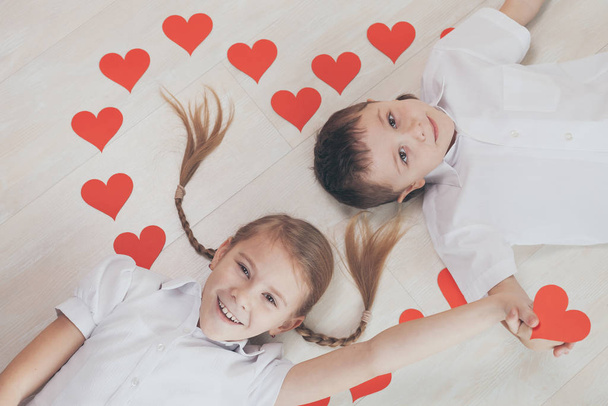 little boy and girl lying on the floor. Concept of happy Valentine day and Brother And Sister Together Forever - Fotó, kép