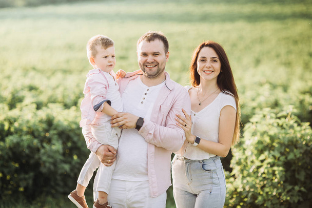 Happy family posing on a green field - Fotografie, Obrázek