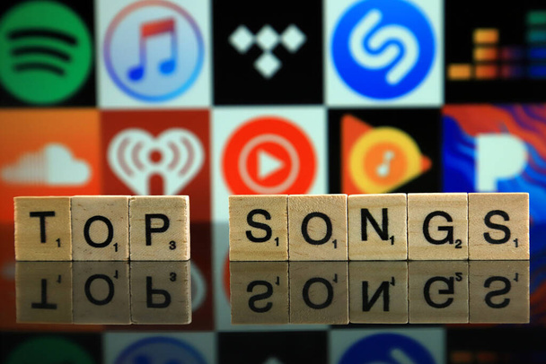 WROCLAW, POLAND - FEBRUARY 19, 2020: Words TOP SONGS made of wooden letters, and SPOTIFY, ITUNES, TIDAL, SHAZAM, DEEZER, SOUNDCLOUD, IHEART RADIO, YOUTUBE MUSIC, GOOGLE PLAY MUSIC, PANDORA logos. - Fotografie, Obrázek