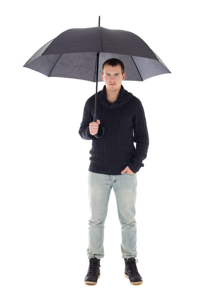 young man in winter clothes posing with umbrella isolated on whi - Foto, Bild