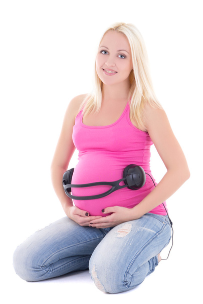 terhes nő a hasán fejhallgató - Fotó, kép