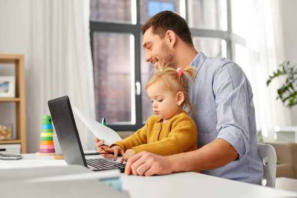 working father with baby daughter at home office - Photo, Image