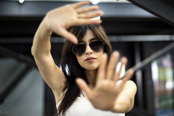 girl in black glasses waves her hands - Photo, Image