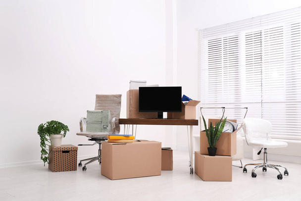 Cardboard boxes and packed belongings in office. Moving day - Zdjęcie, obraz