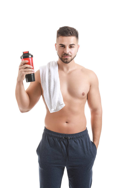 Sporty man with protein shake on white background - Photo, Image