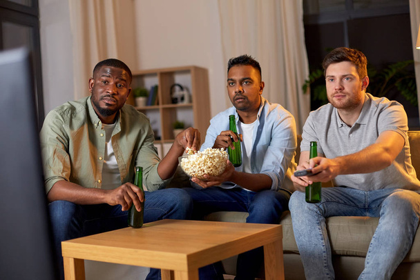 male friends with beer watching tv at home - Fotoğraf, Görsel
