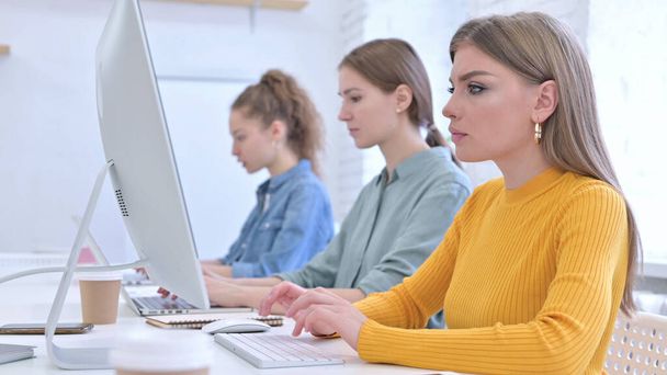Creative Female Team Working on Desktop and Laptop - 写真・画像