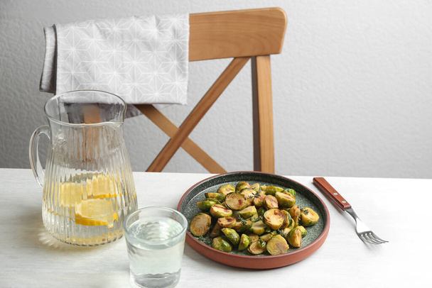 Delicious roasted brussels sprouts served on white wooden table - Fotografie, Obrázek