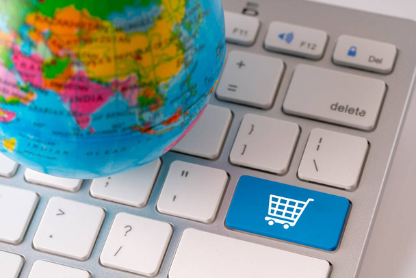 Online shopping icon with globe for global concept  - Zdjęcie, obraz