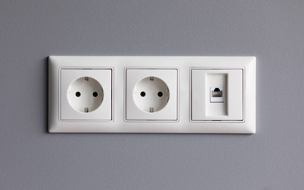 Modern white house outlet on gray wall closeup - Zdjęcie, obraz