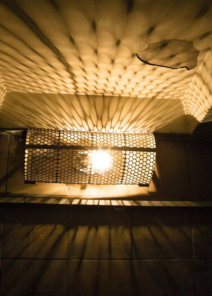 Electric lamp covered with metal mesh. Close-up. - Photo, Image