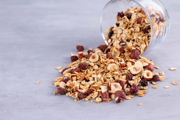 Homemade Granola with almond, raisins and hazelnuts on a gray background - Photo, Image