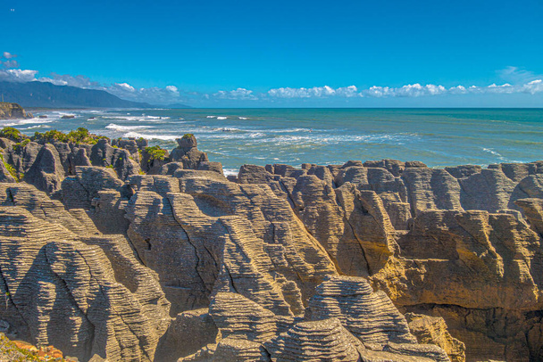 Pancake Rocks in sunny weather in summer at Tasmanian Sea, New Zealand. Royalty free stock photo. - Foto, imagen