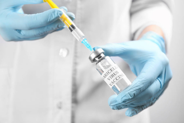 Doctor filling syringe with chickenpox vaccine, closeup. Varicella virus prevention - Valokuva, kuva