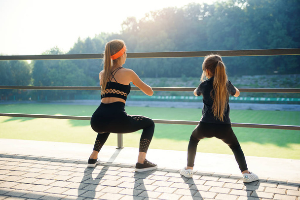 Sporty couple doing jump exercise during fitness workout at outdoor stadium - Valokuva, kuva