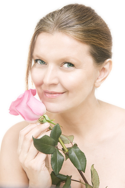 Attractive mid adult woman with a pink rose , female face of bea - Fotoğraf, Görsel