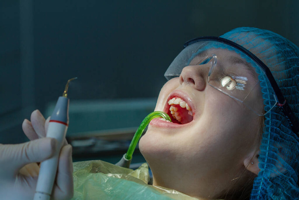 Mädchen beim Zahnarzttermin. Untersuchung der Mundhöhle und der Zähne bei einem Kind. - Foto, Bild