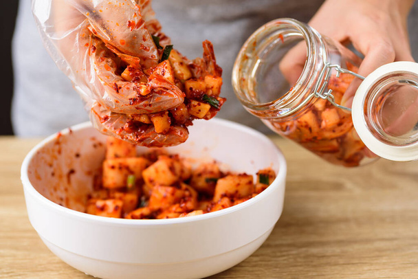 Kimchi rzodkiewka gotowania i fermentacji w słoiku, domowe koreańskie jedzenie - Zdjęcie, obraz