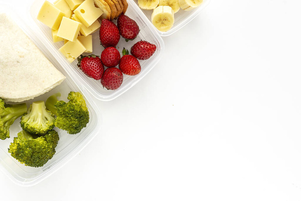 Food in Plastic containers ready to eat from above To take away. On white background. Healthy food. Isolated. Flat lay - 写真・画像