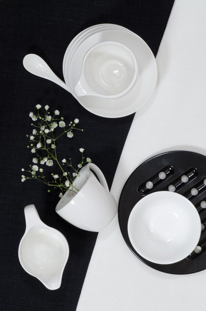 White porcelain on black and white linen tablecloths. - Photo, Image