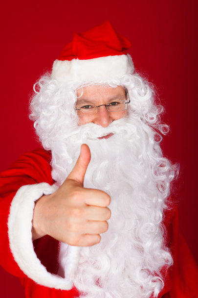 Santa gesturing thumb-up - Foto, immagini